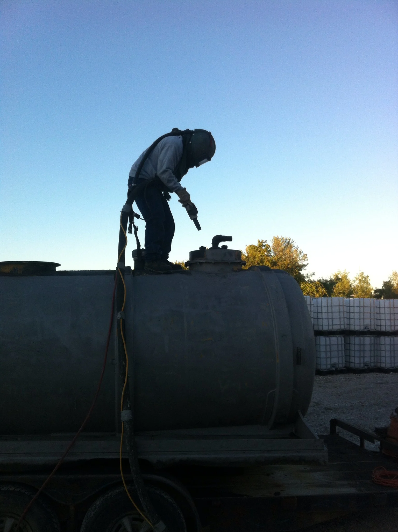 A Peculiar Services blaster on top of a tank at dusk