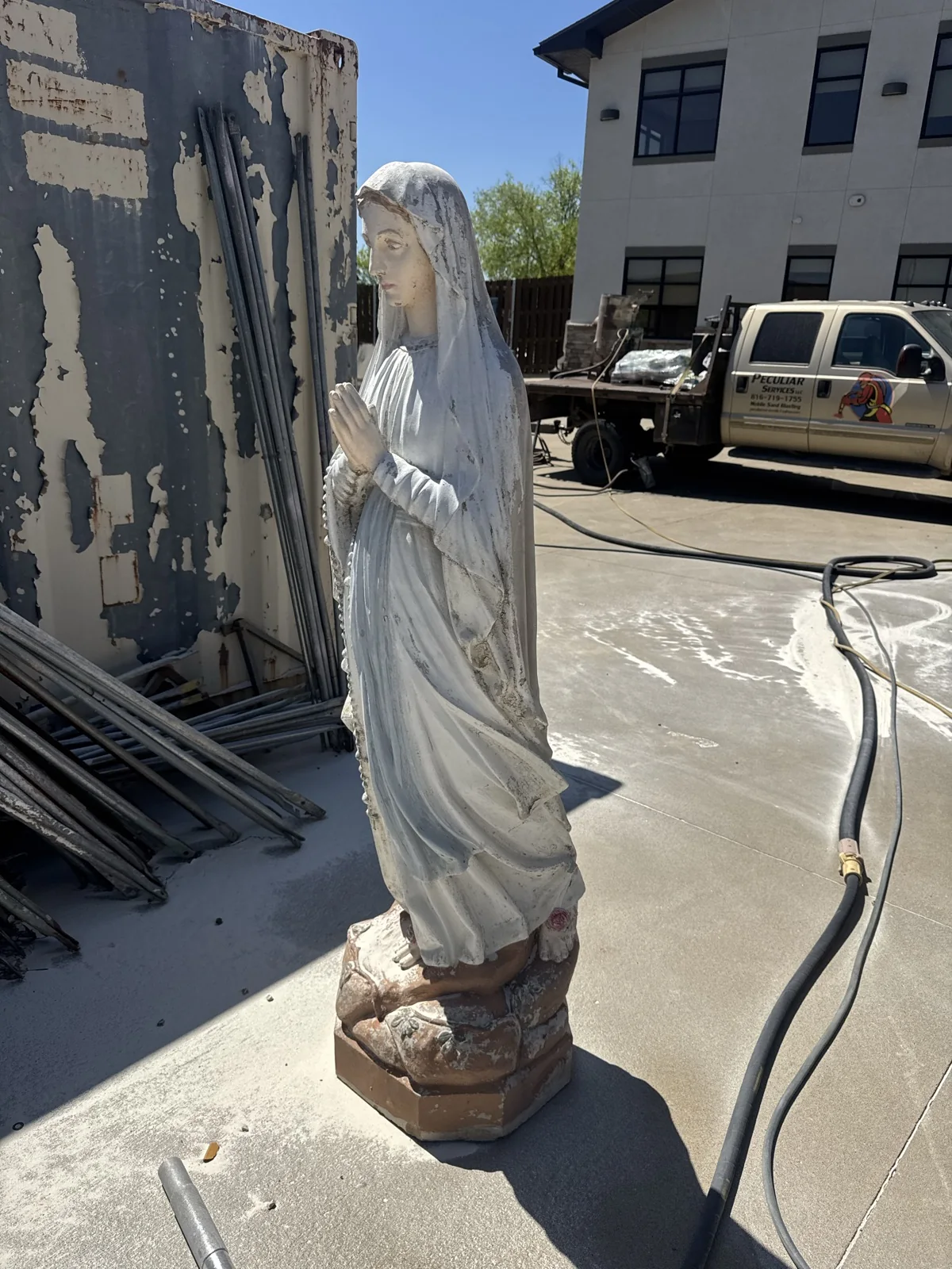Cast stone statue still grey under old paint