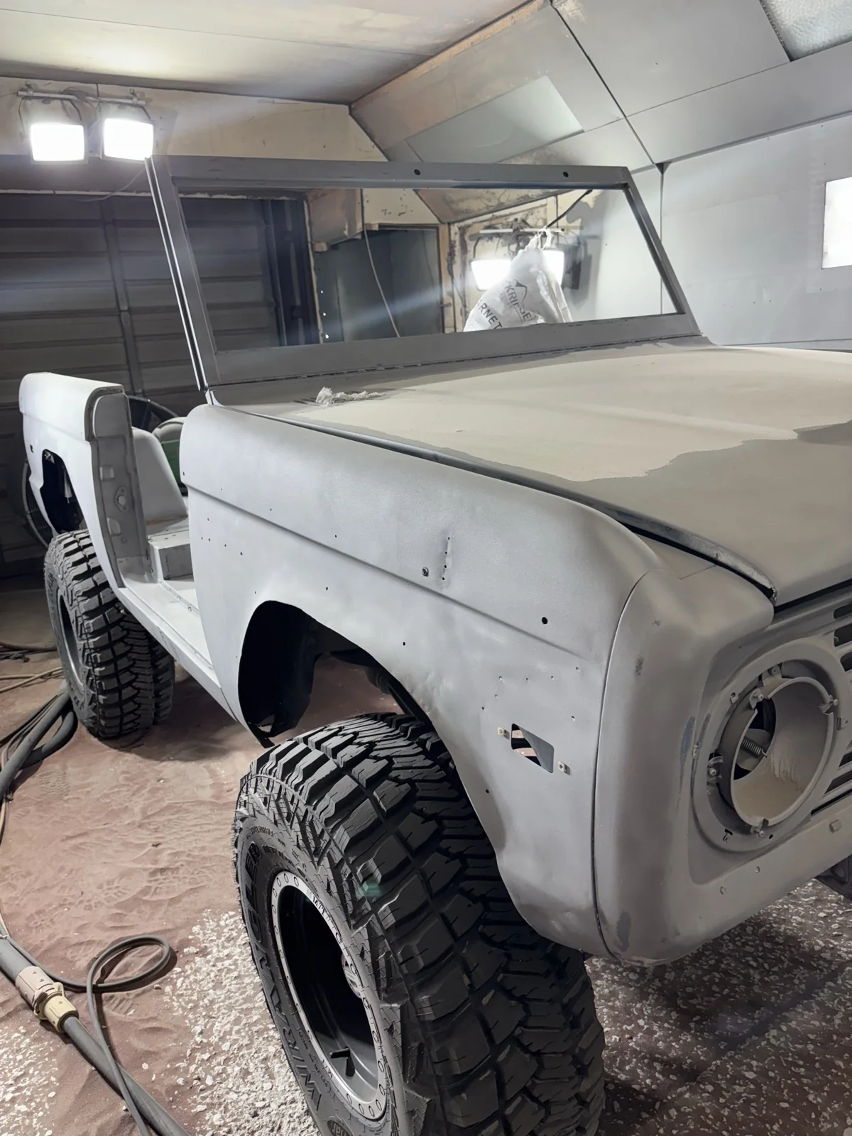 The same Bronco blasted to bare metal in the booth