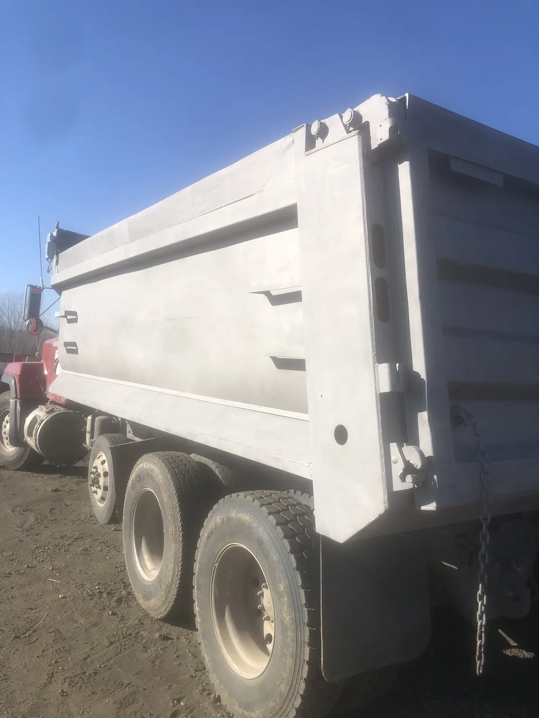 The same dump bed after blasting, uniform bare steel