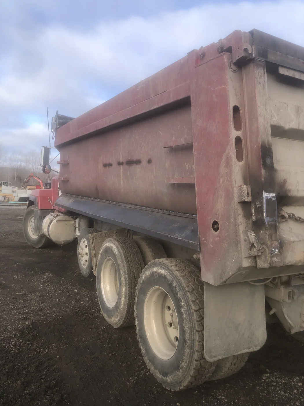 Dump truck bed with faded, chalked paint before blasting