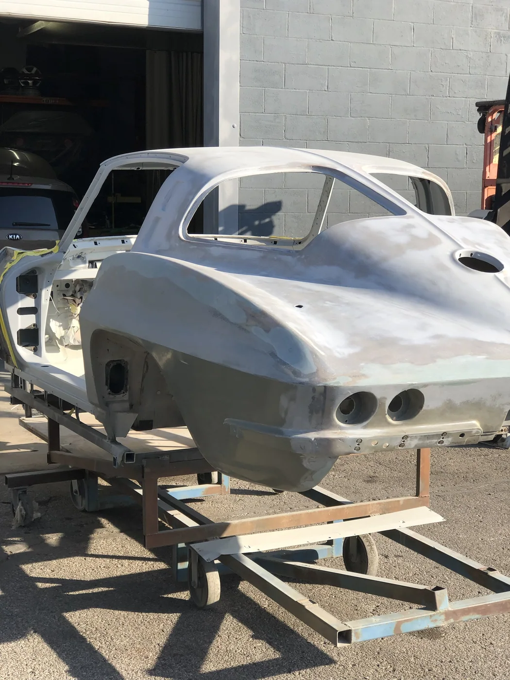 Corvette body stripped to bare fibreglass, every curve even